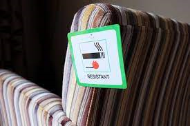 Labelled upholstered furniture showing the sign for “match test” a sign consisting green square with a black smoking object and a match