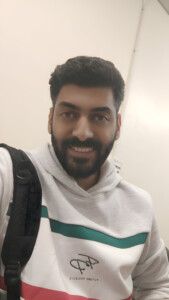 Photo of man wearing a white hooded top.