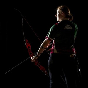 Photograph of a woman holding a bow and arrow.