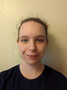 Head and shoulders photo of a woman against a plain background.