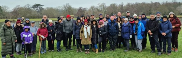 This image is an outdoor setting in spring. Around 35 walkers from the Dadima’s Community Walking Group and four Open University researchers are celebrating walking in nature.