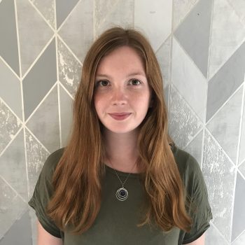 Mailes Rachel photo Photograph of a woman standing in front of a patterned background.