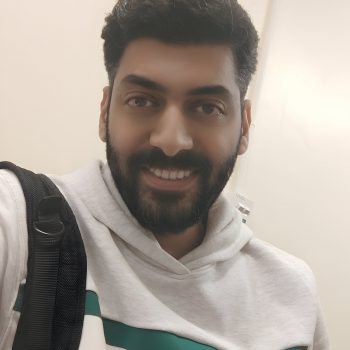 Photo of man wearing a white hooded top.